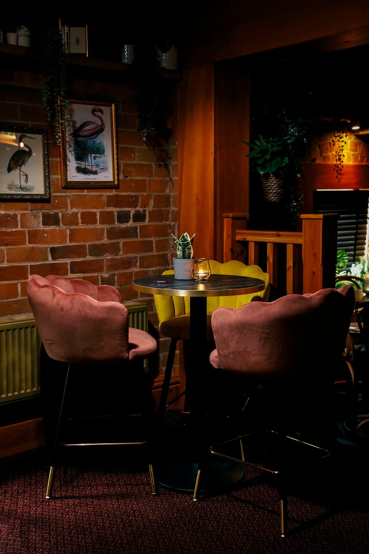 White Cocktail Bar at The Hart, Headless Cross, Redditch, featuring stylish pink and yellow lounge seating, exposed brick walls and warm ambient lighting for private parties and celebrations.