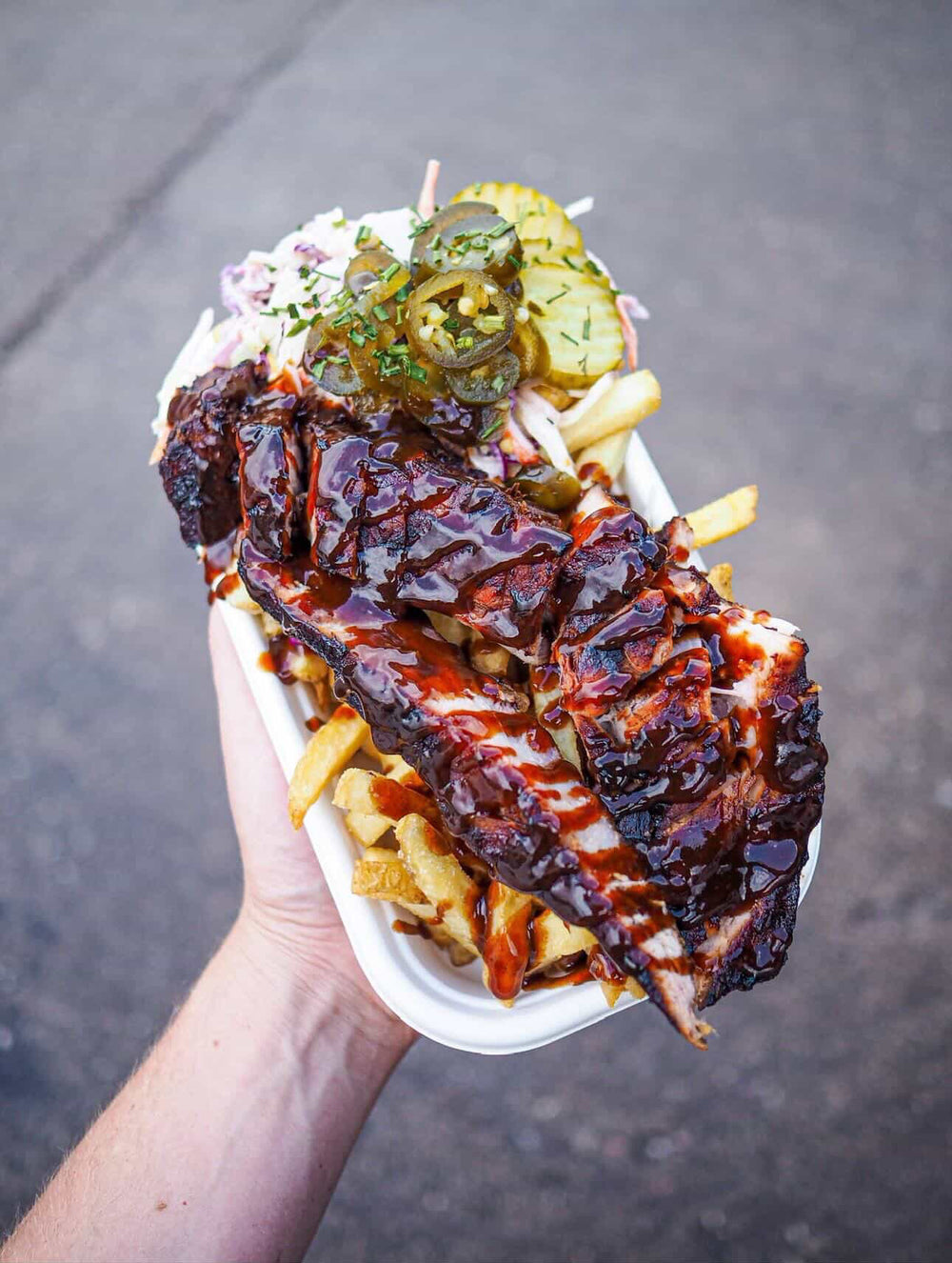 Loaded BBQ ribs glazed in rich sauce with fries, slaw and pickled jalapeños at Street Food Sundays