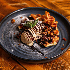 Golden banana waffle topped with vanilla ice cream, chocolate sauce, biscuit crumble and fresh mint at The Hart in Redditch
