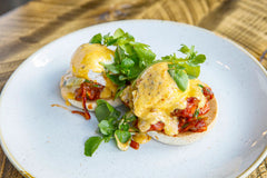 The Hart pulled pork Benedict served on toasted muffins with creamy hollandaise sauce and fresh greens in Redditch