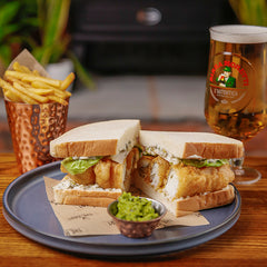 The Hart winter fish finger sandwich with lettuce, tartare sauce, fries and a pint of beer in Redditch