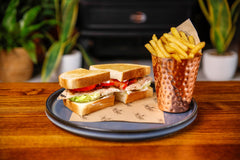 The Hart winter grilled chicken club sandwich with lettuce, tomato and fries in Redditch