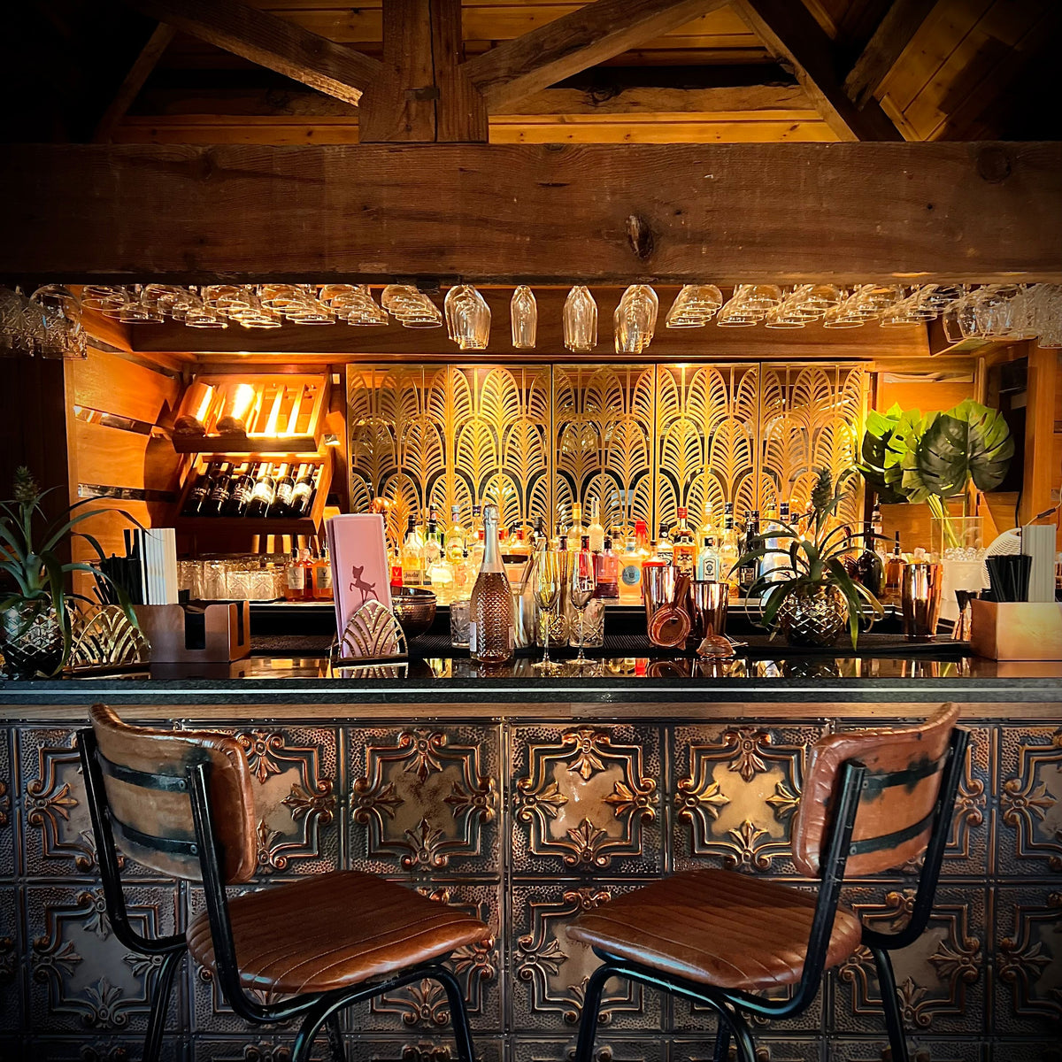 White Cocktail Bar at The Hart, Headless Cross, Redditch, a stylish private hire events space with a statement cocktail bar, warm lighting, ornate copper detailing and seating for private parties.